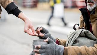 a-midsection-of-woman-giving-money-to-homeless-beg-2026-03-10-03-13-47-utc.jpg